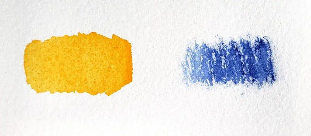 On the left is a swatch of orange paint that contains more water. On the right is a swatch of blue pigment that contains less water.