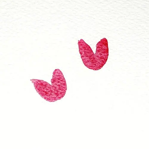 There is an image of two watercolor tulip bulbs, and they are painted in the color red. This is the first step in the how to paint watercolor tulips tutorial.
